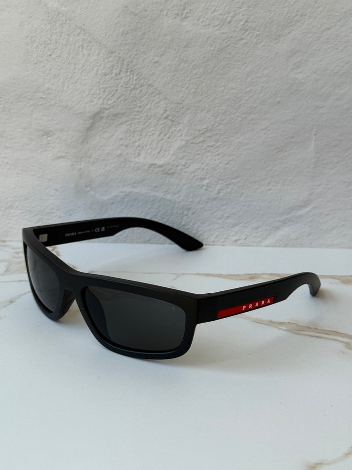 Black Prada Sport sunglasses, angled view with dark lenses and temple logo