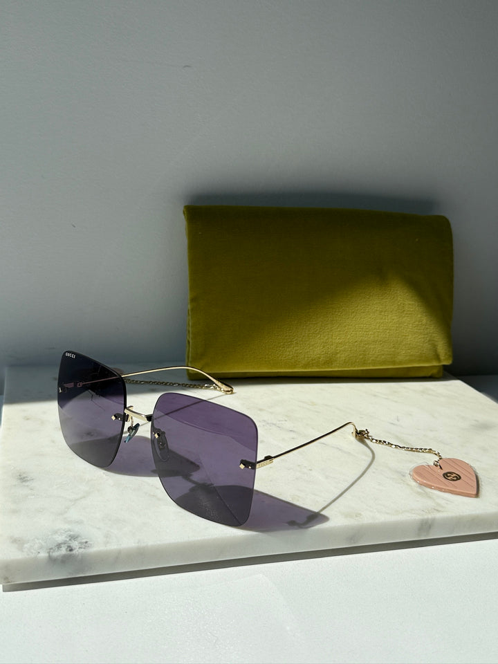 Gafas de sol cuadradas sin montura Gucci GG1147S con cadena verde 