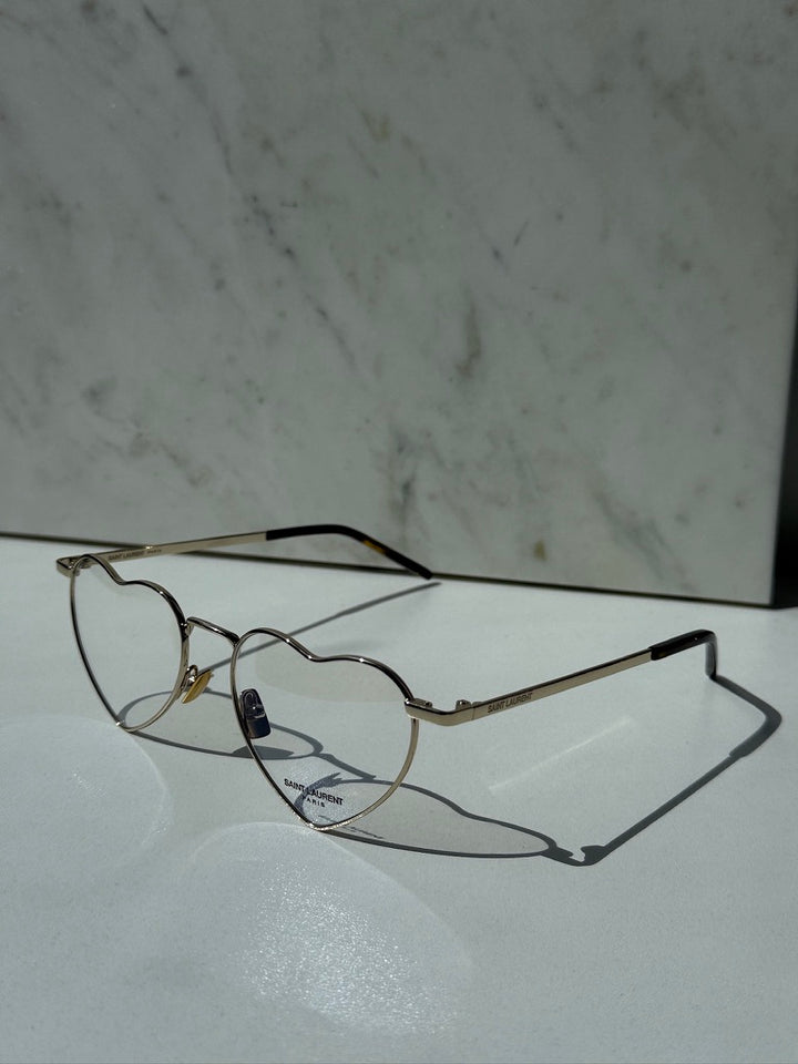 Saint Laurent LouLou optical frames, gold metal, heart-shaped clear lenses, side view