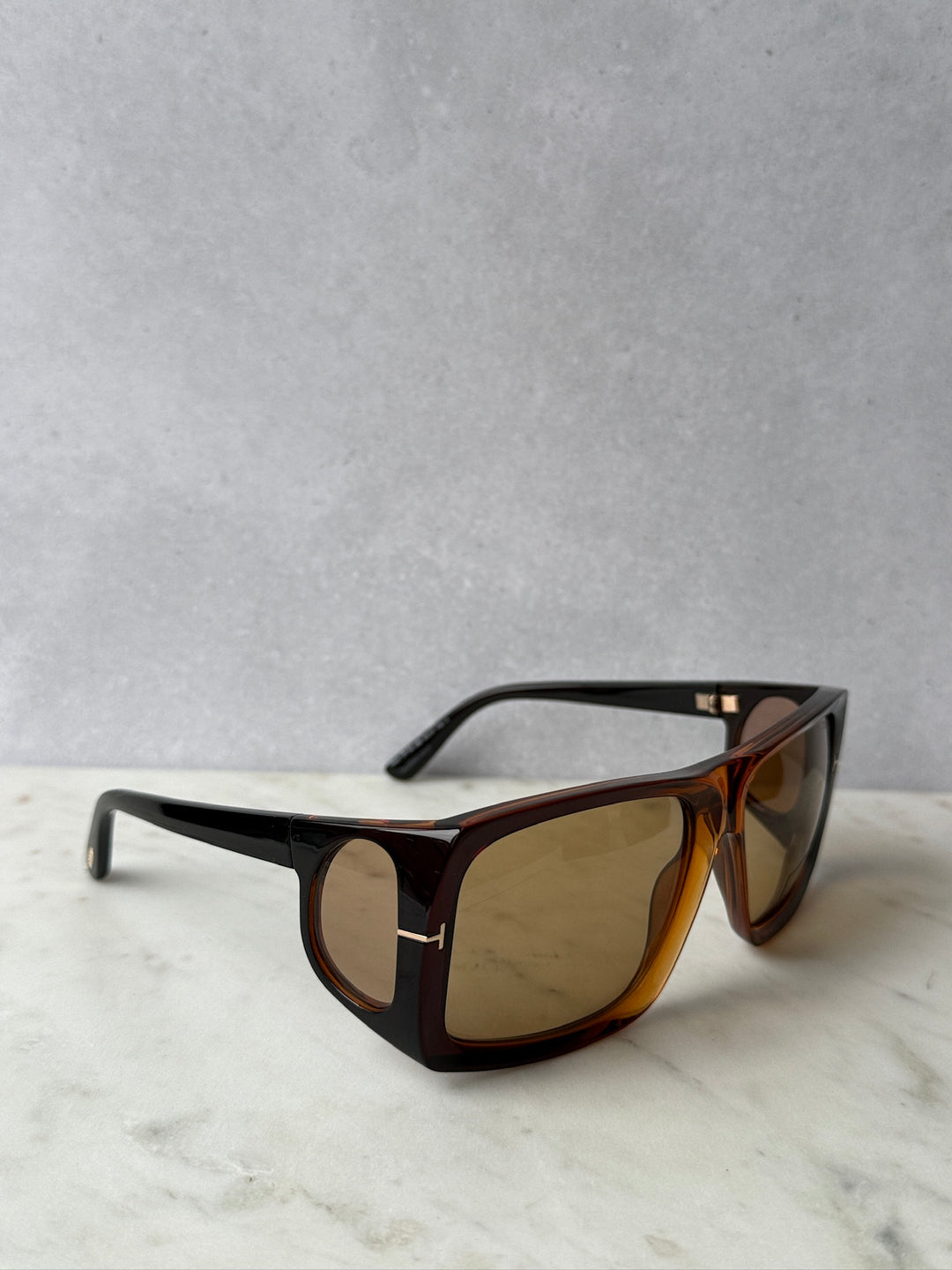 Side view of brown tortoise sunglasses with amber lenses and black temples
