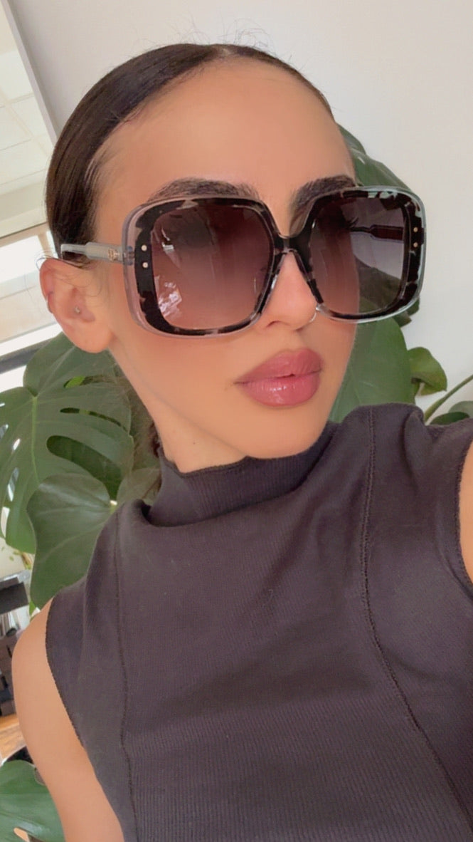 Dior square sunglasses with dark tinted lenses on face