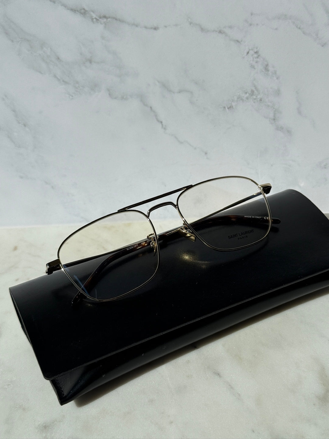 Gold aviator eyeglass frames with dark-tinted lenses and thin metal temples.