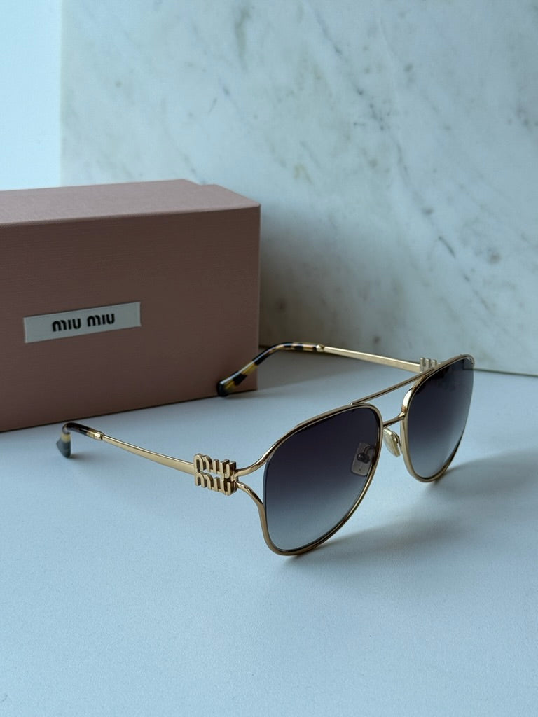 Miu Miu gold aviator sunglasses with dark lenses and bow-shaped metal temple tips