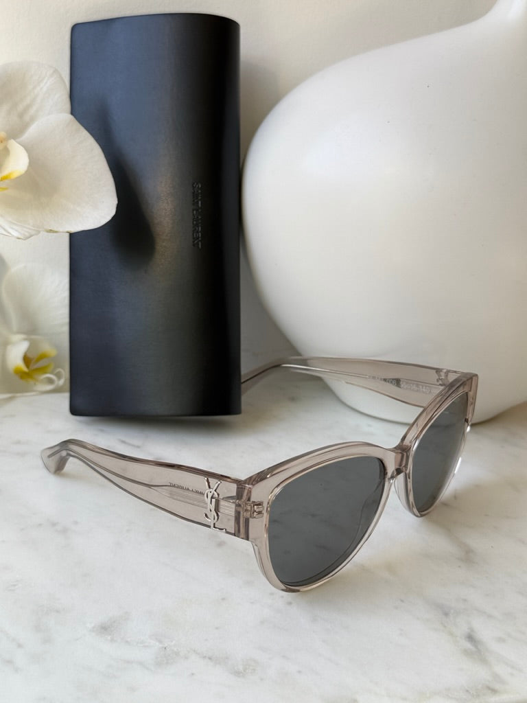 Cat-eye sunglasses with clear silver frame and dark gray lenses, side view