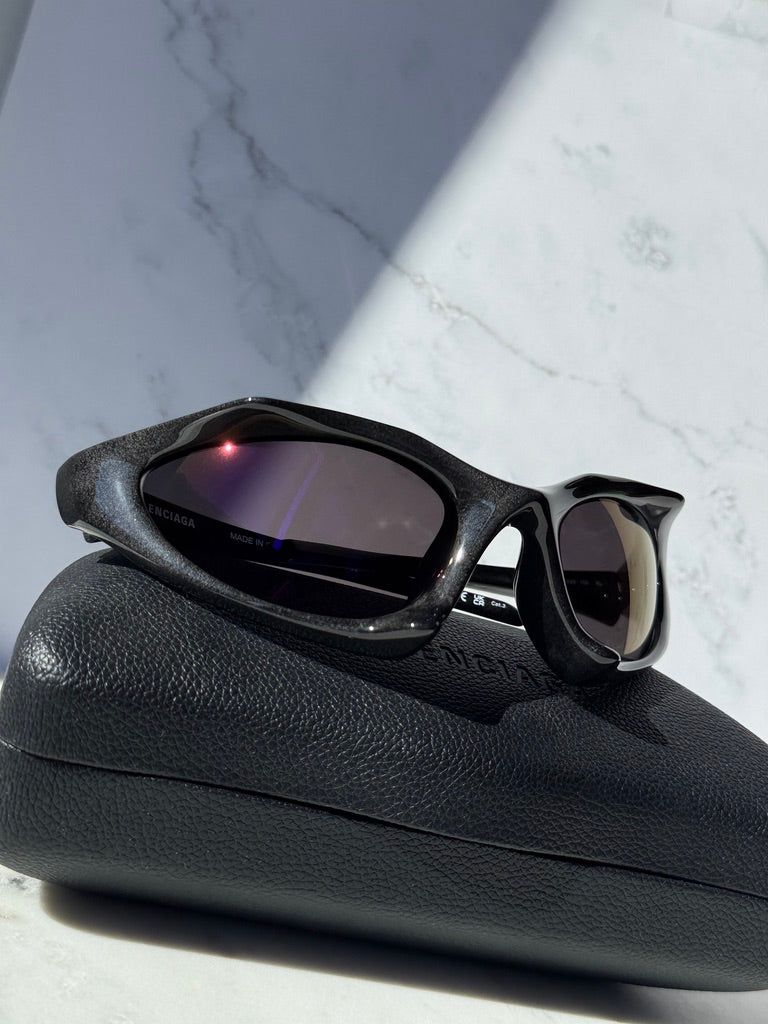 Black runner mask sunglasses with mirrored lenses and curved wraparound frame