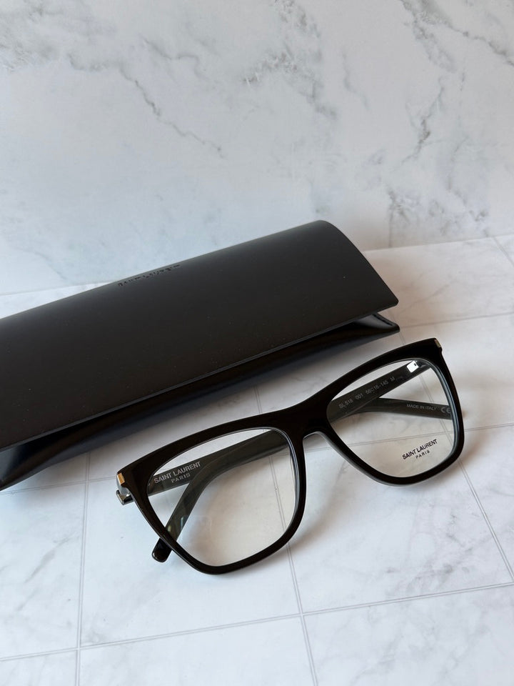 Black rectangular eyeglass frames with clear lenses and dark acetate temples