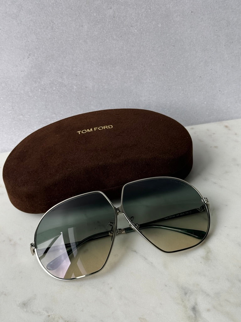 Oversized silver-toned sunglasses with dark green lenses and silver hinges