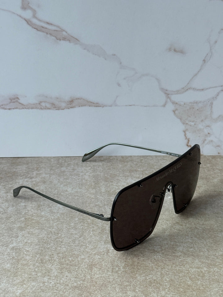 Black oversized mask sunglasses with angular temples and dark tint lenses