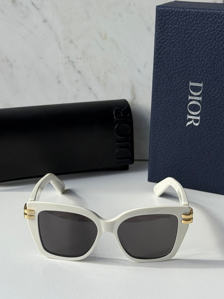 Oversized butterfly sunglasses with white frame, dark lenses, and gold metal accents