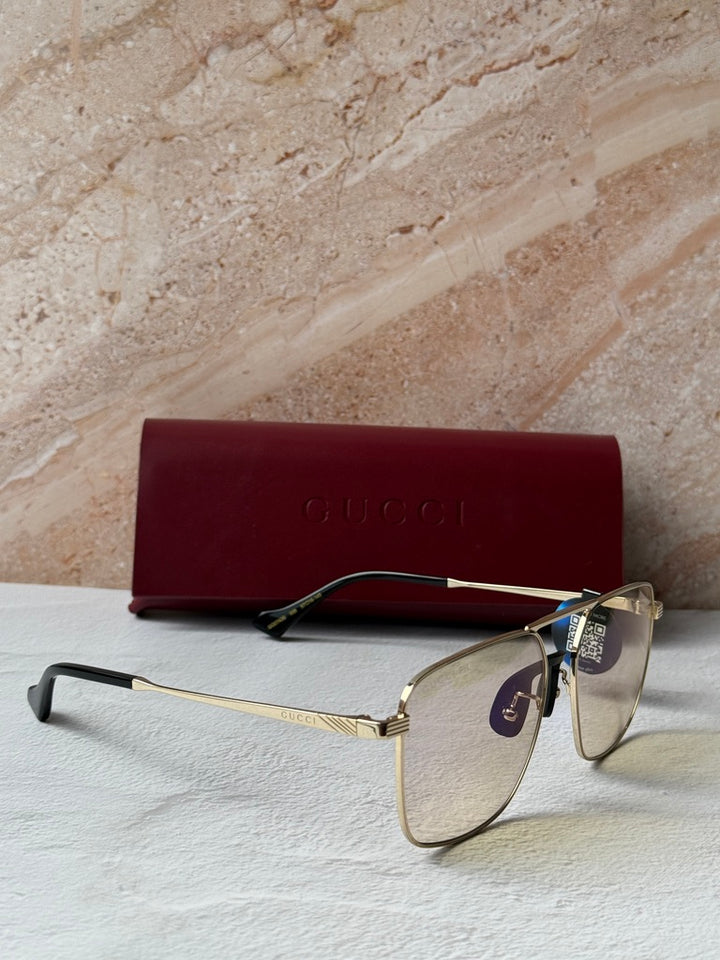 Gucci gold metal pilot sunglasses with photochromic lenses and black temple arms