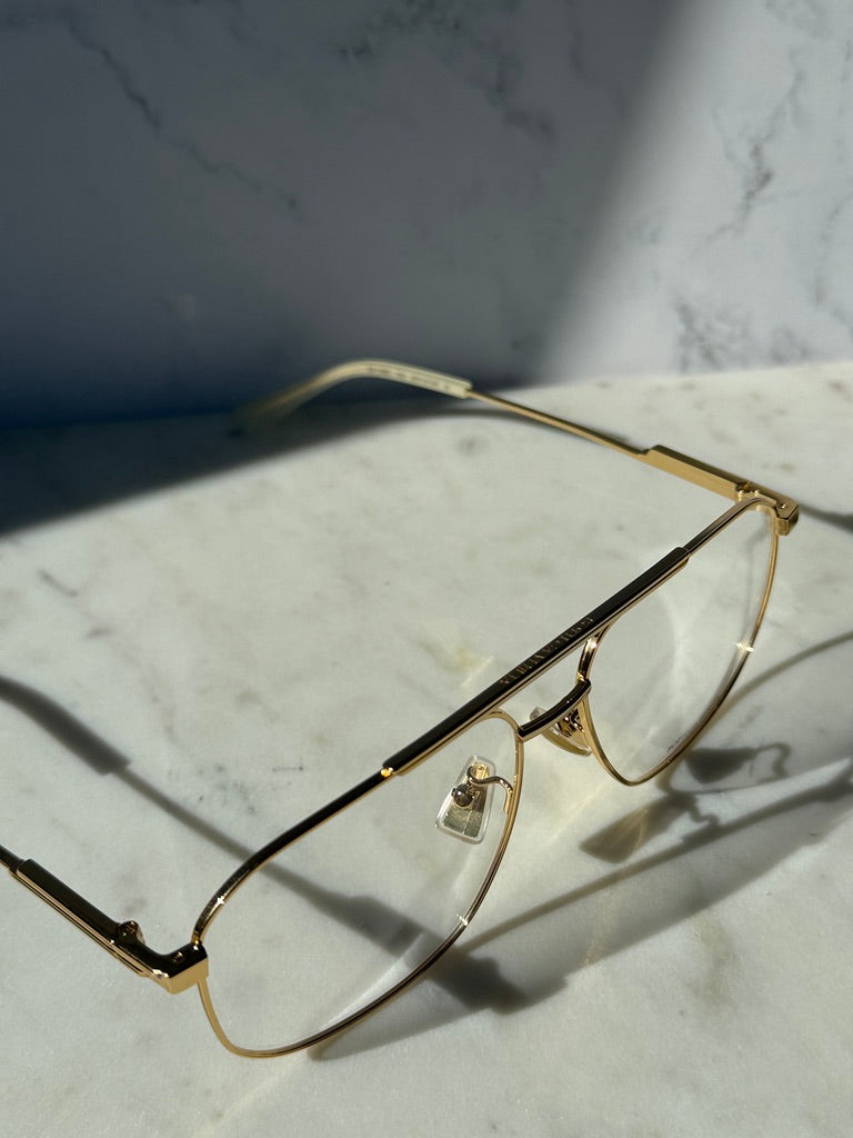 Gold pilot eyeglass frames with clear lenses, rectangular aviator shape