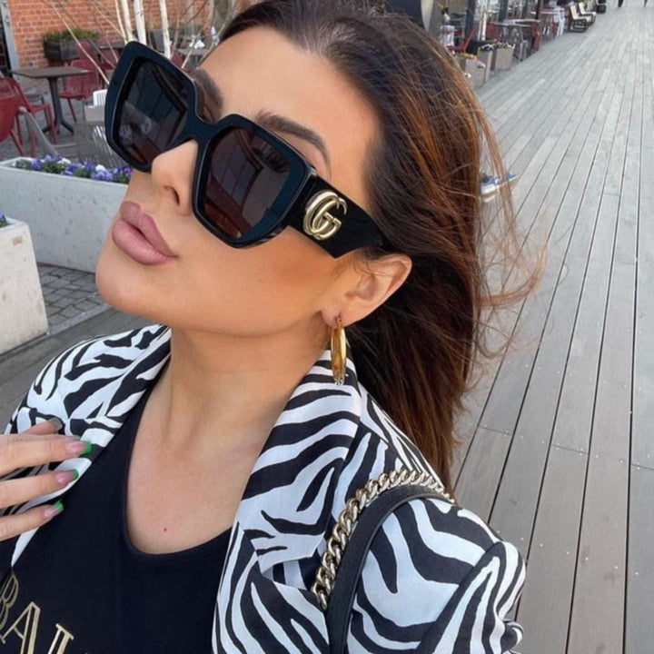 Oversized black sunglasses with square frames and dark lenses, GG logo on temple