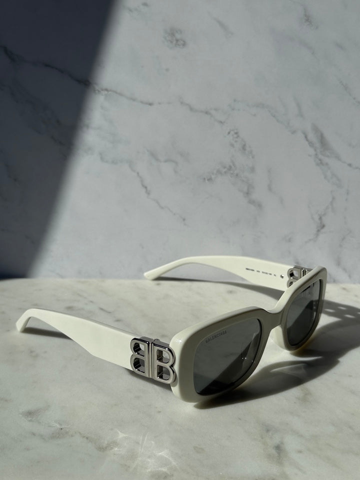 White square sunglasses with dark lenses, side view with B logo temple