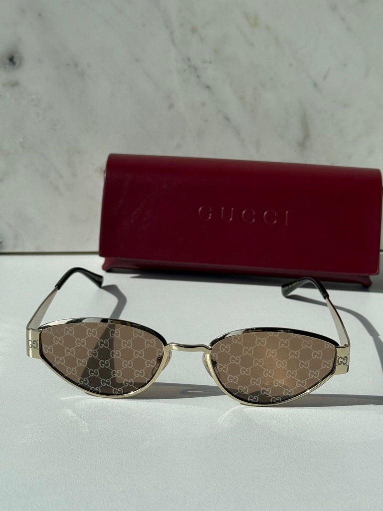 Gucci cat-eye sunglasses with GG monogram lenses and slim gold-tone frame