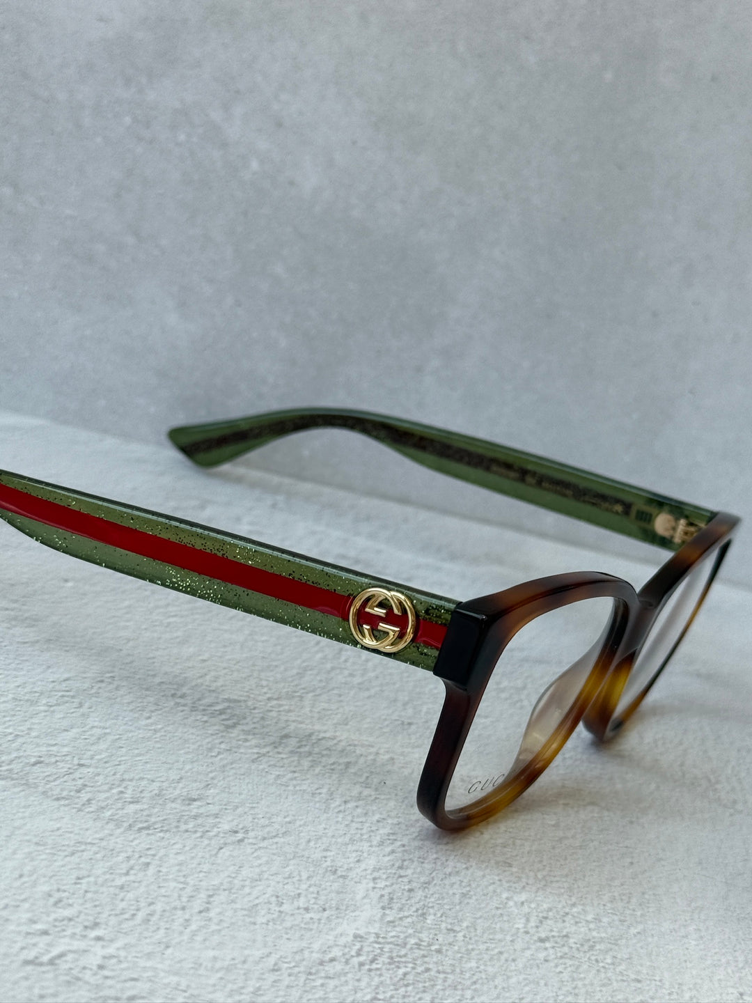 Monturas de anteojos Gucci GG0038ON con patas a rayas marrones