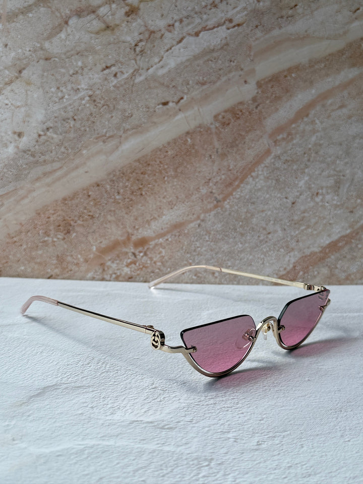 Gucci half-rim sunglasses side view, gold frame with pink lenses