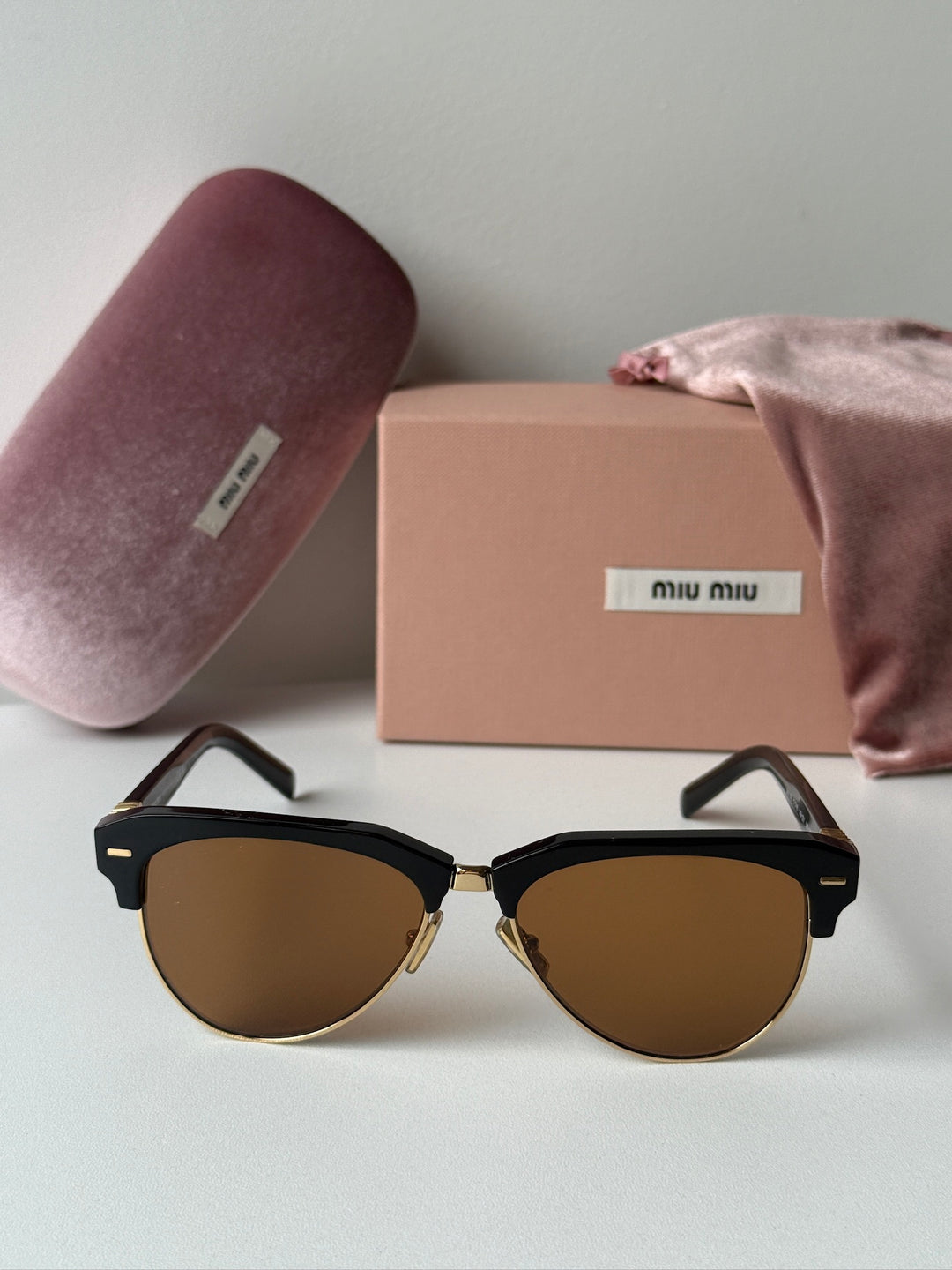 Miu Miu black cat-eye sunglasses with brown tinted lenses with box and dust bag