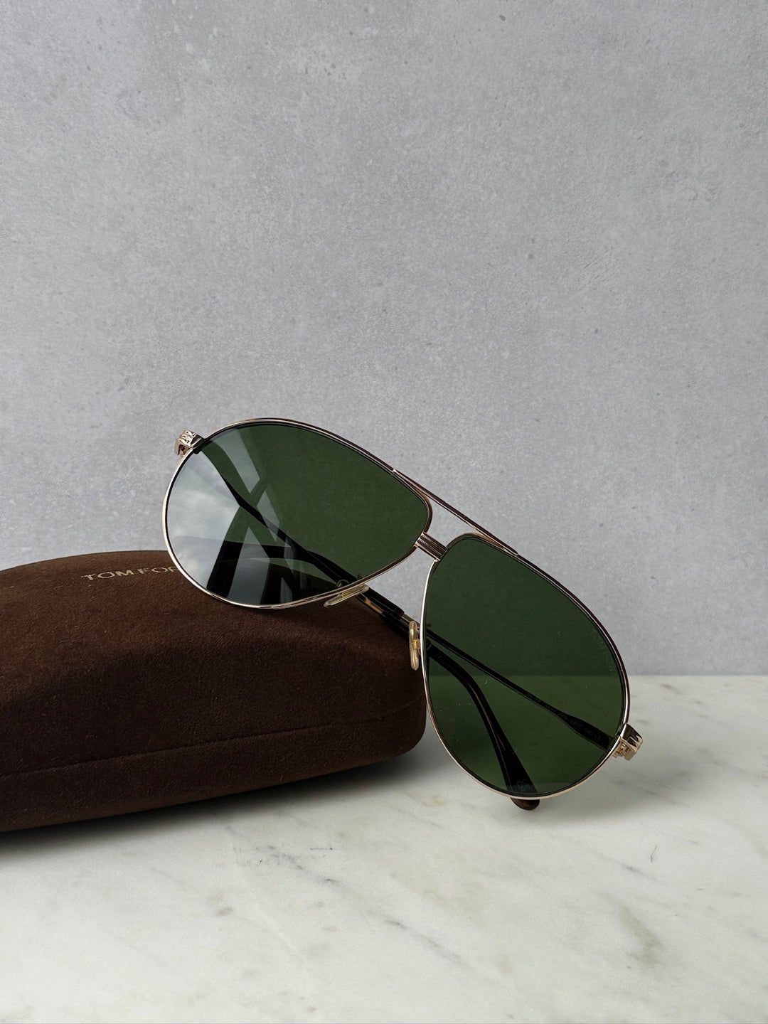 Rose gold aviator sunglasses with dark green mirrored lenses