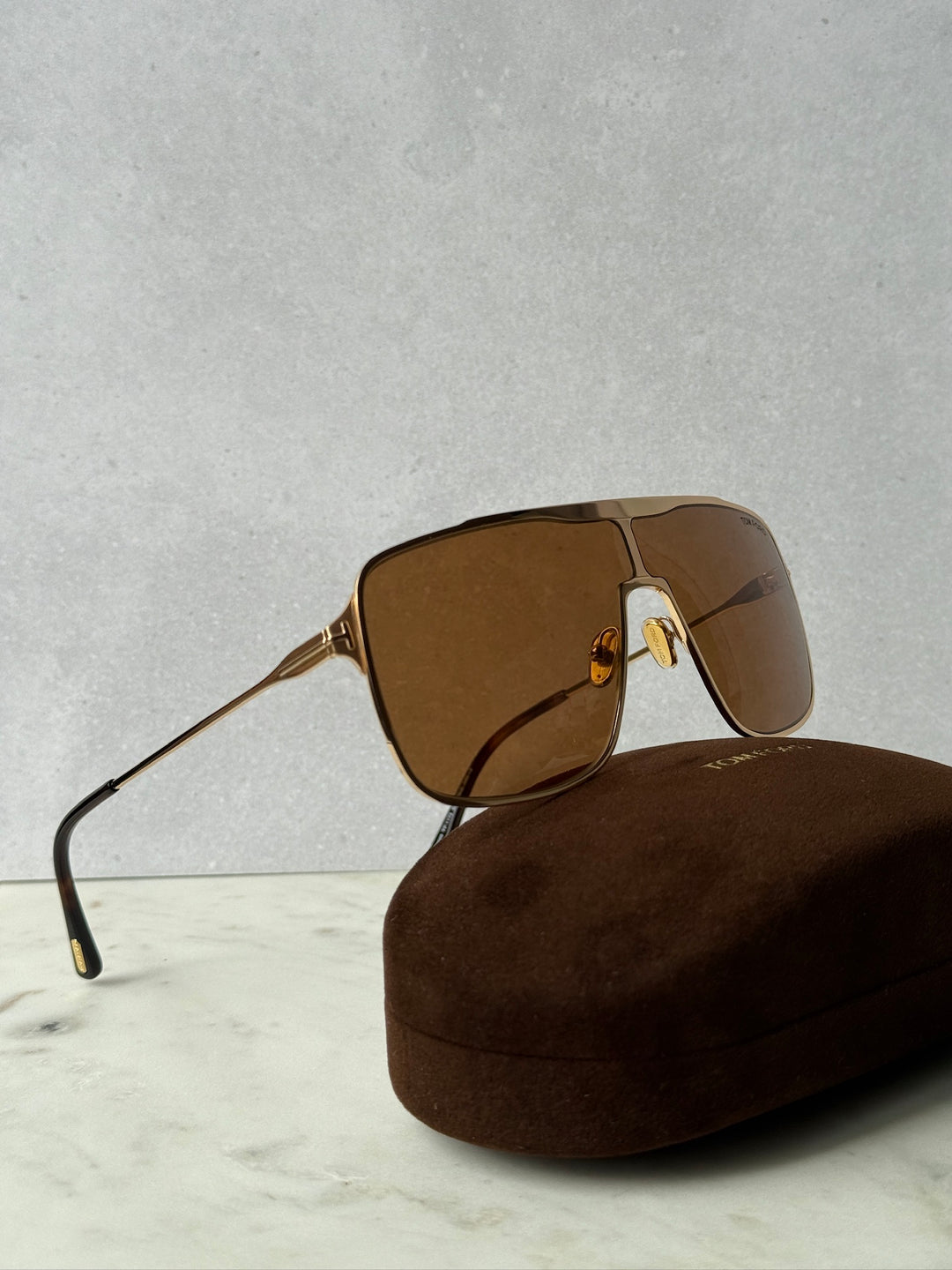 Gold-tone aviator sunglasses with brown tinted lenses and thin metal frame