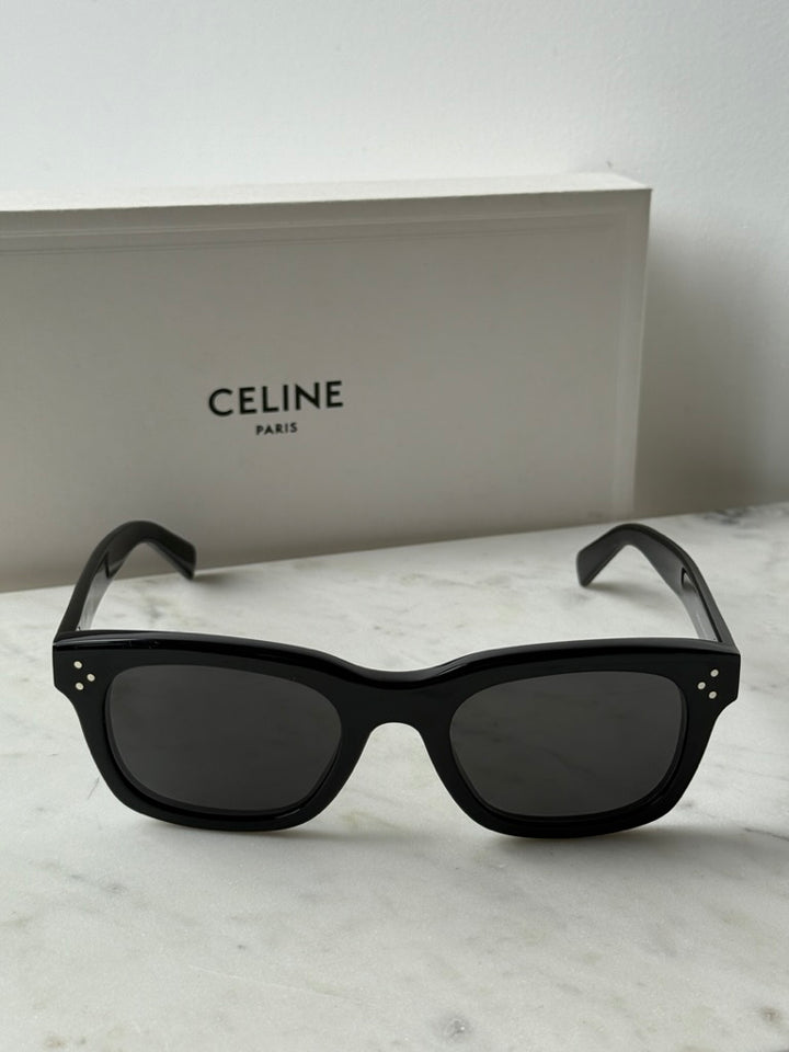 Black unisex sunglasses with dark lenses, wide front view