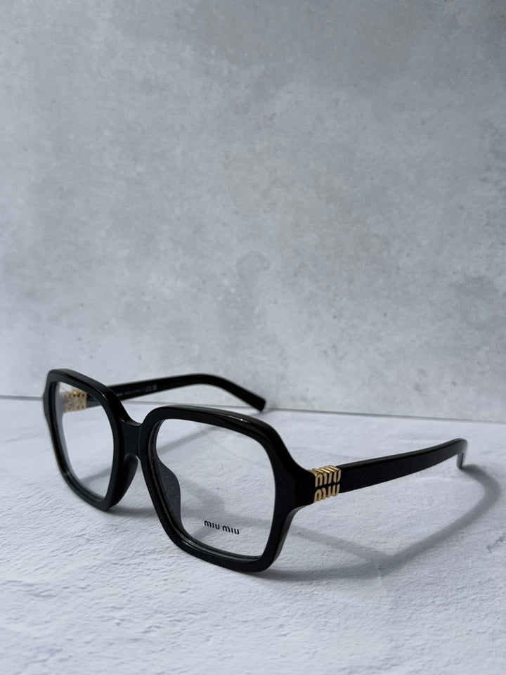 Black square eyeglass frames, side profile with gold temple detailing