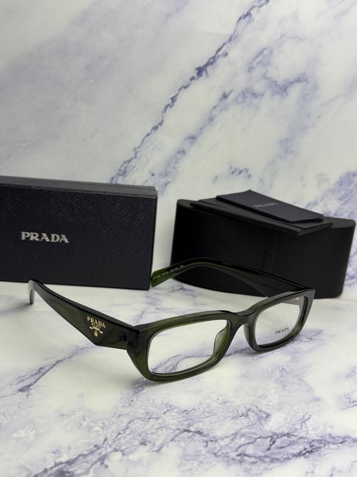 Transparent green rectangular eyeglass frames with black Prada case in view.
