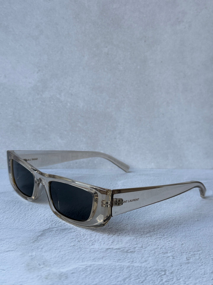 Saint Laurent SL553 slim sunglasses, transparent frame with dark lenses and metal temples