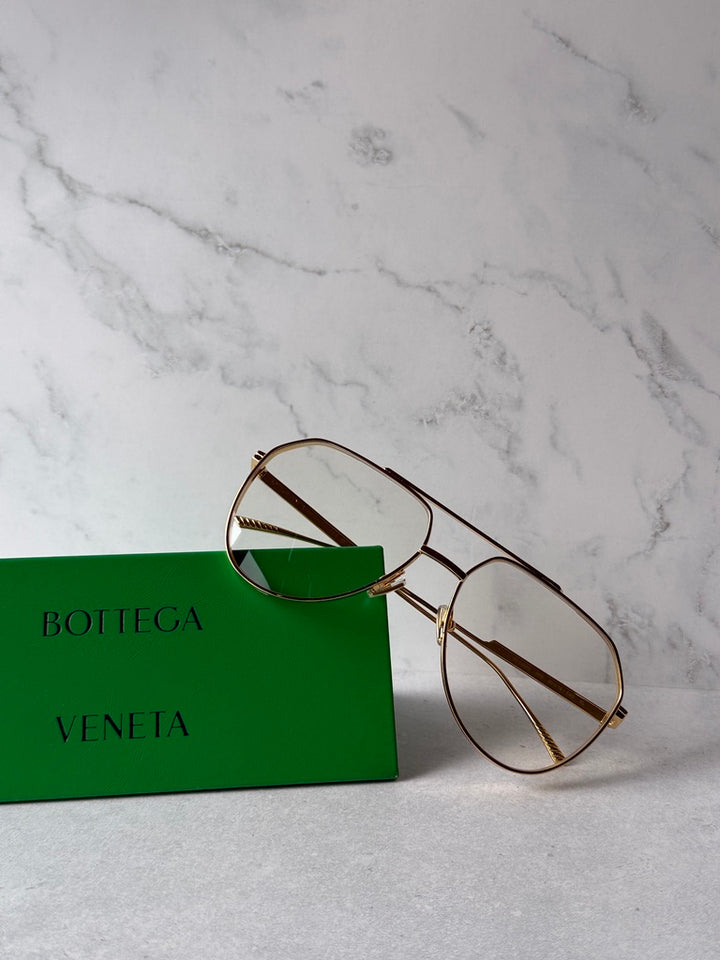 Gold aviator sunglasses with green-tinted lenses and rectangular rim side view