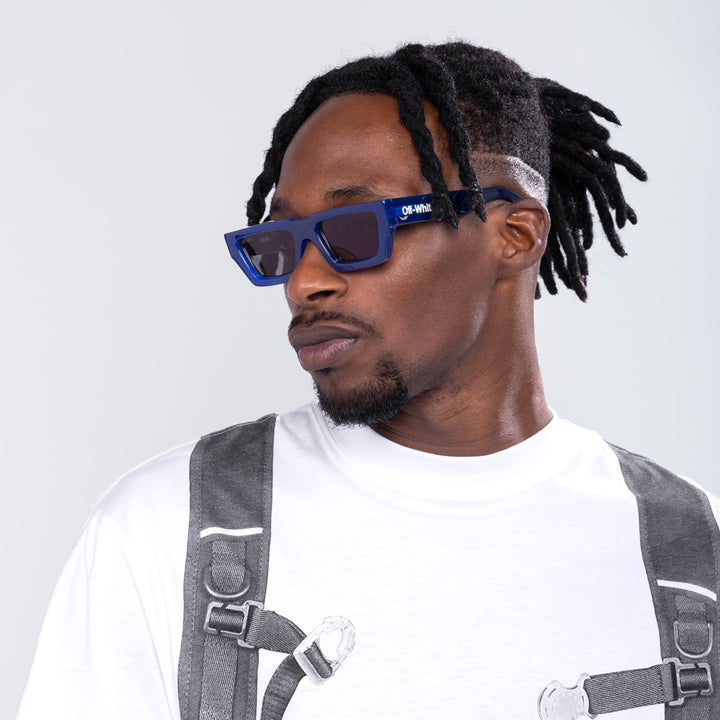 Blue square sunglasses with dark lenses and Off-White logo on the temple arms.