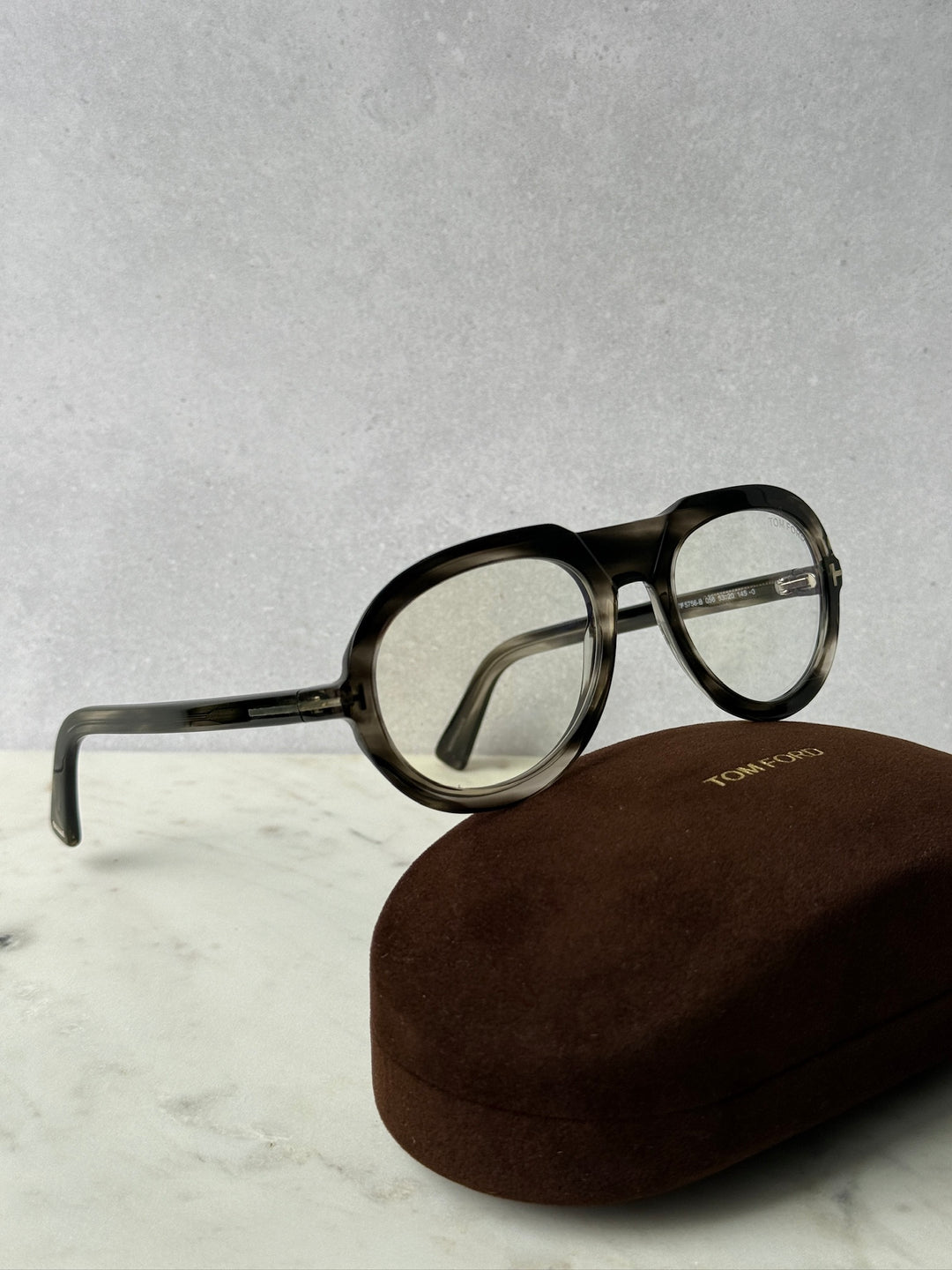 Round dark Havana eyeglass frames with clear lenses and curved metal temples