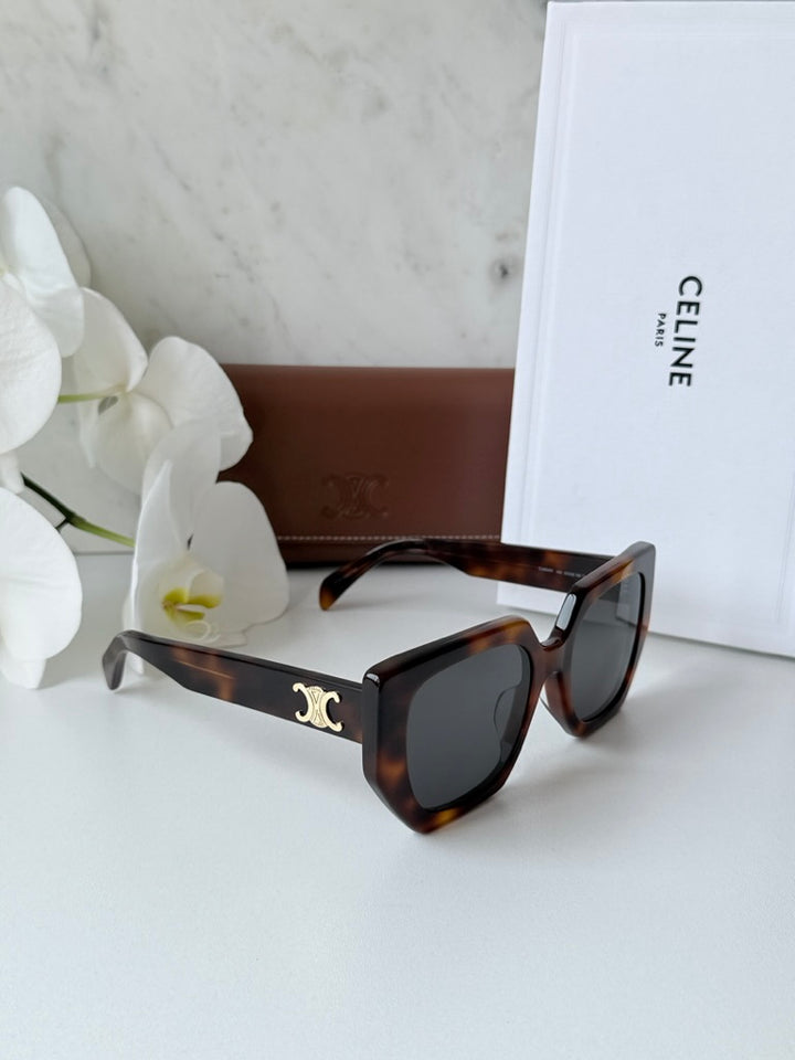 Square cat-eye sunglasses, brown tortoise frame with dark lenses and gold Triomphe temple logo