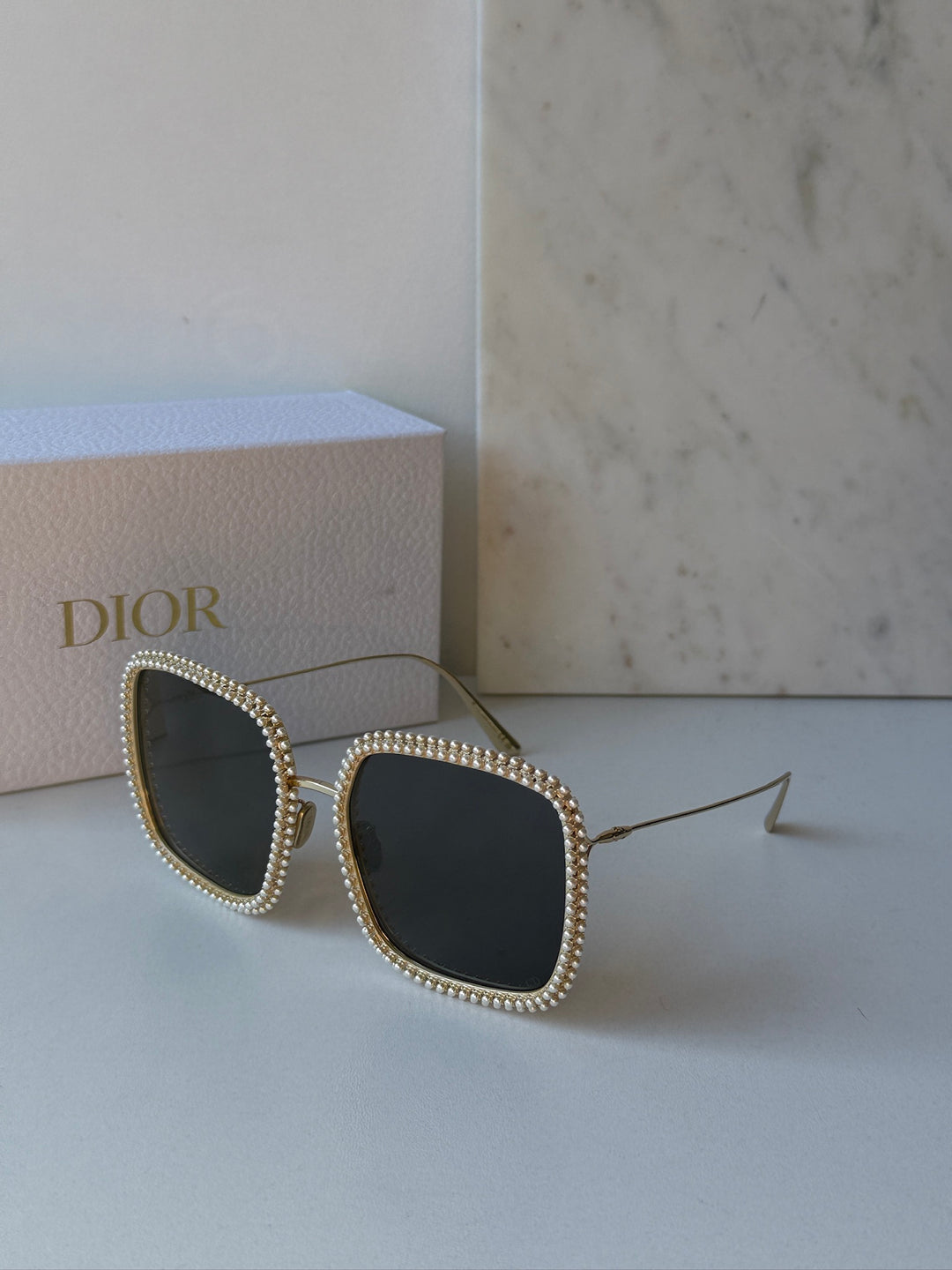 Gold rhinestone cat-eye sunglasses with dark lenses and thin metal arms