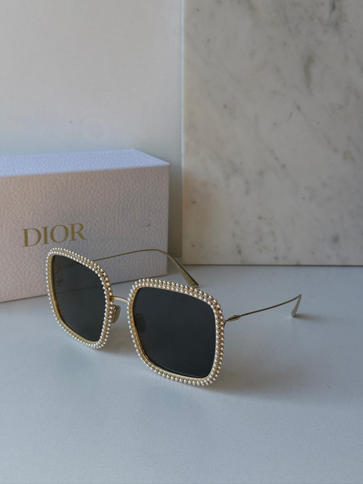 Gold rhinestone cat-eye sunglasses with dark lenses and thin metal arms