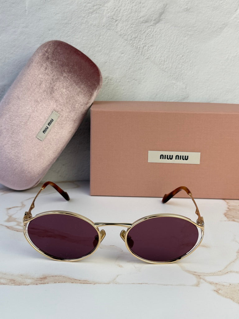 Miu Miu gold oval sunglasses with violet lenses, front view with case and box.