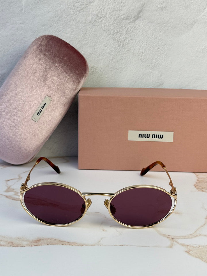 Miu Miu gold oval sunglasses with violet lenses, front view with case and box.