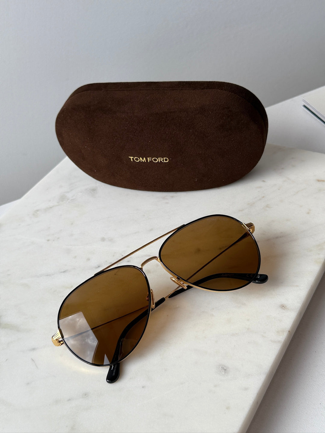 Gold-tone aviator sunglasses with brown lenses and storage case