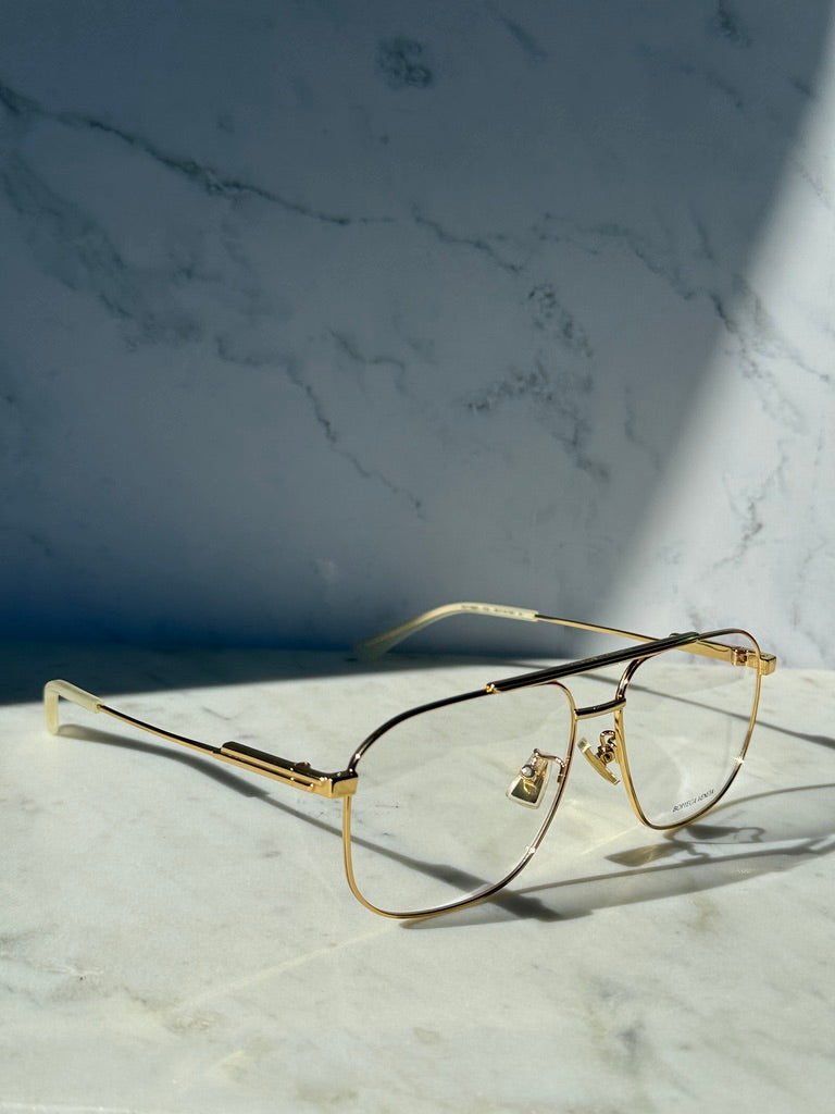Gold pilot eyeglass frames with clear lenses and slim bridge design