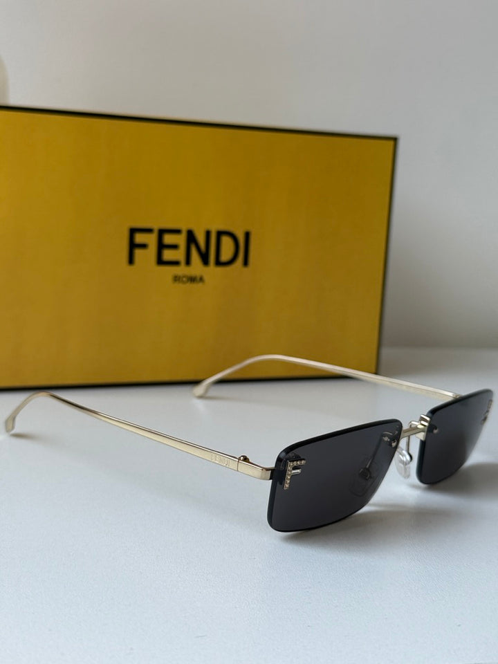 Fendi rimless sunglasses with dark lenses and gold metal frame, side view
