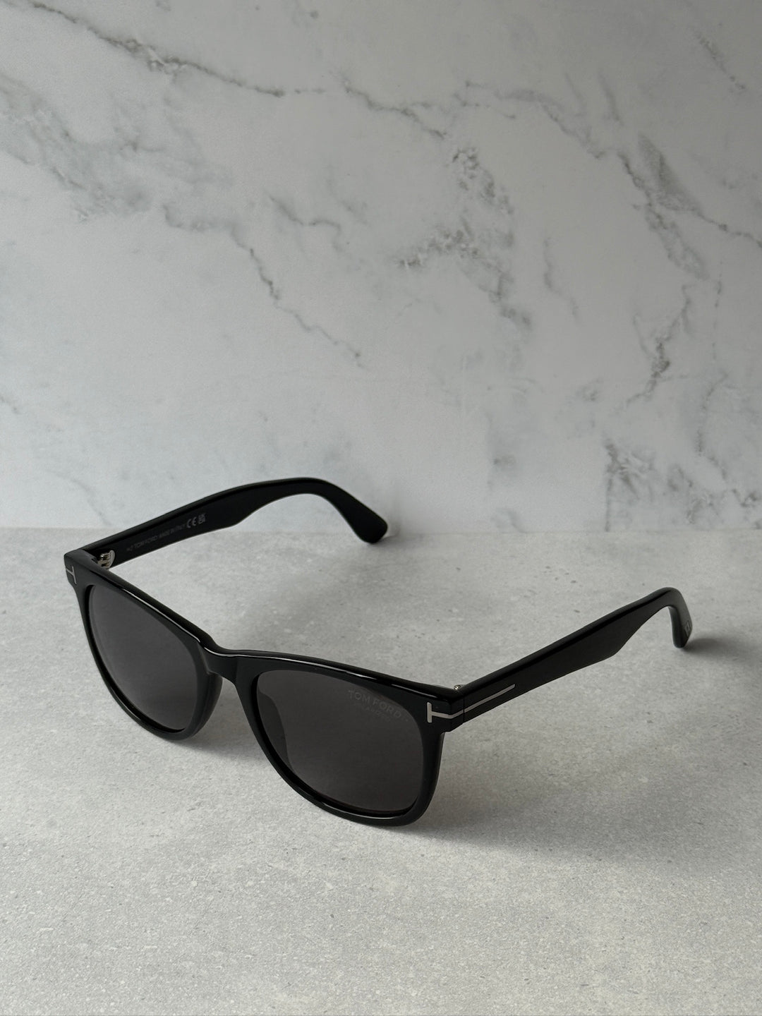 Black angular sunglasses with dark polarized lenses and side logo