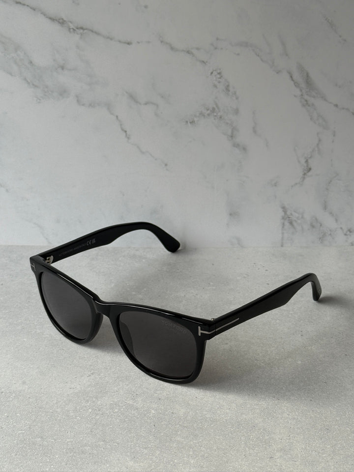 Black angular sunglasses with dark polarized lenses and side logo