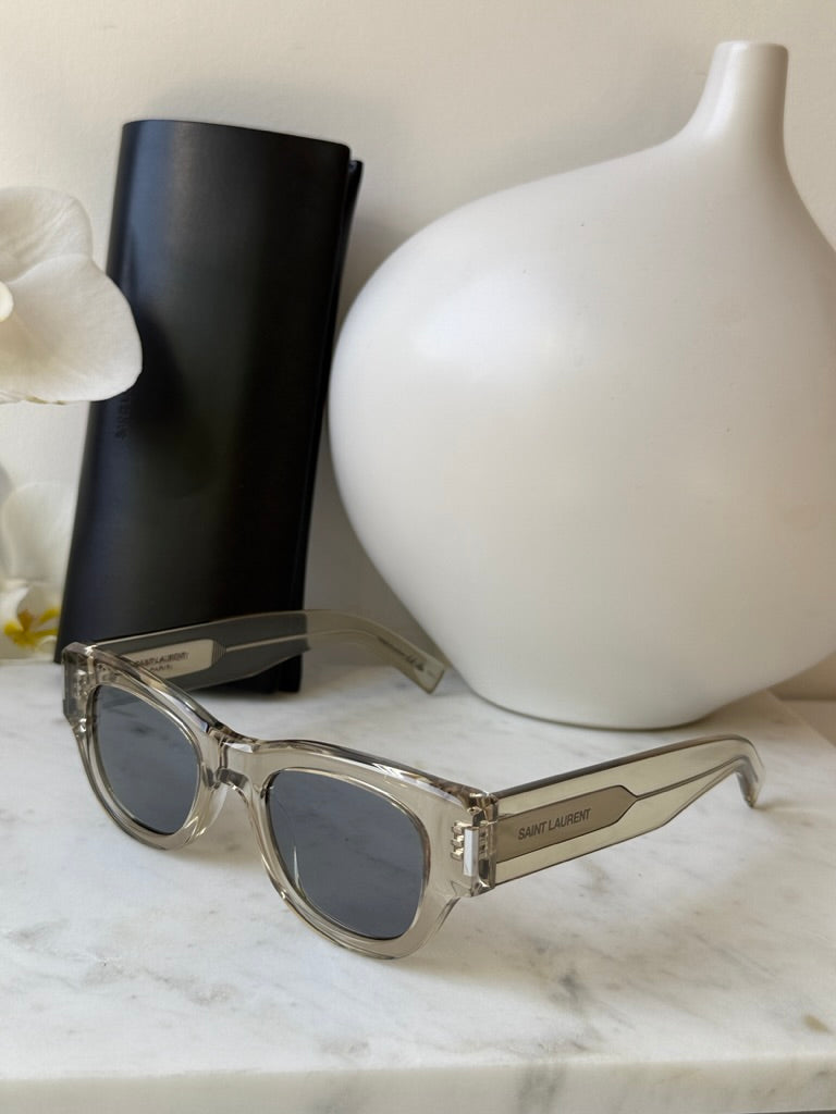 Saint Laurent SL573 clear mirror sunglasses with dark lenses, shown with black case