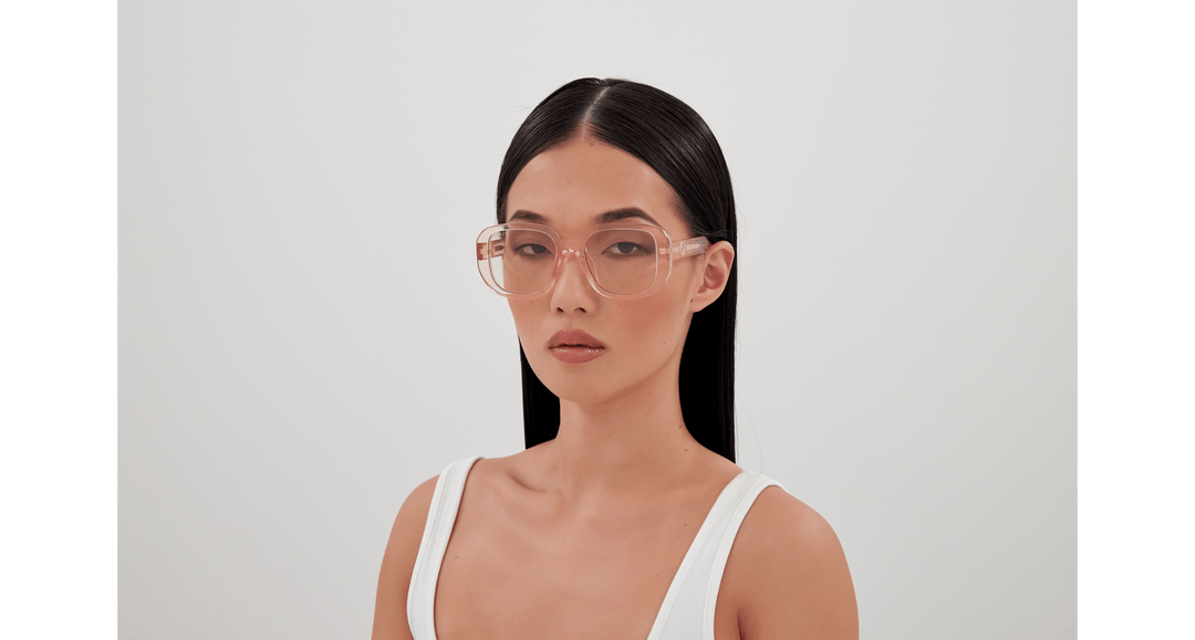 Gucci translucent pink square sunglasses on model, tinted lenses and logo temple