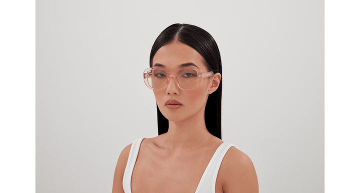 Gucci translucent pink square sunglasses on model, tinted lenses and logo temple