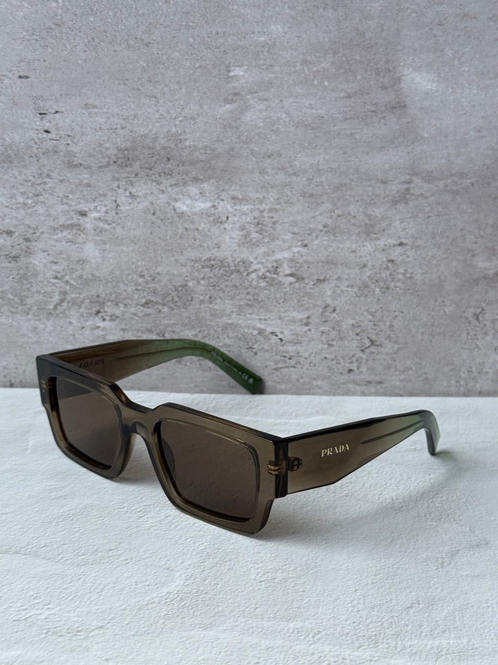 Prada rectangular sunglasses with transparent brown frames, brown lenses, green temples