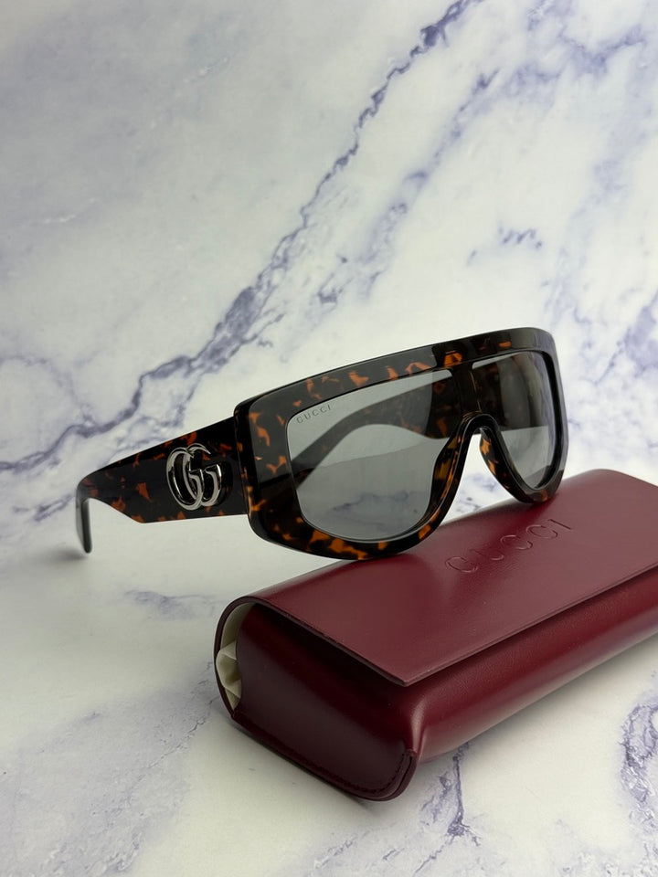 Gucci GG1257S Gafas de sol redondeadas con lentes marrones y rojos