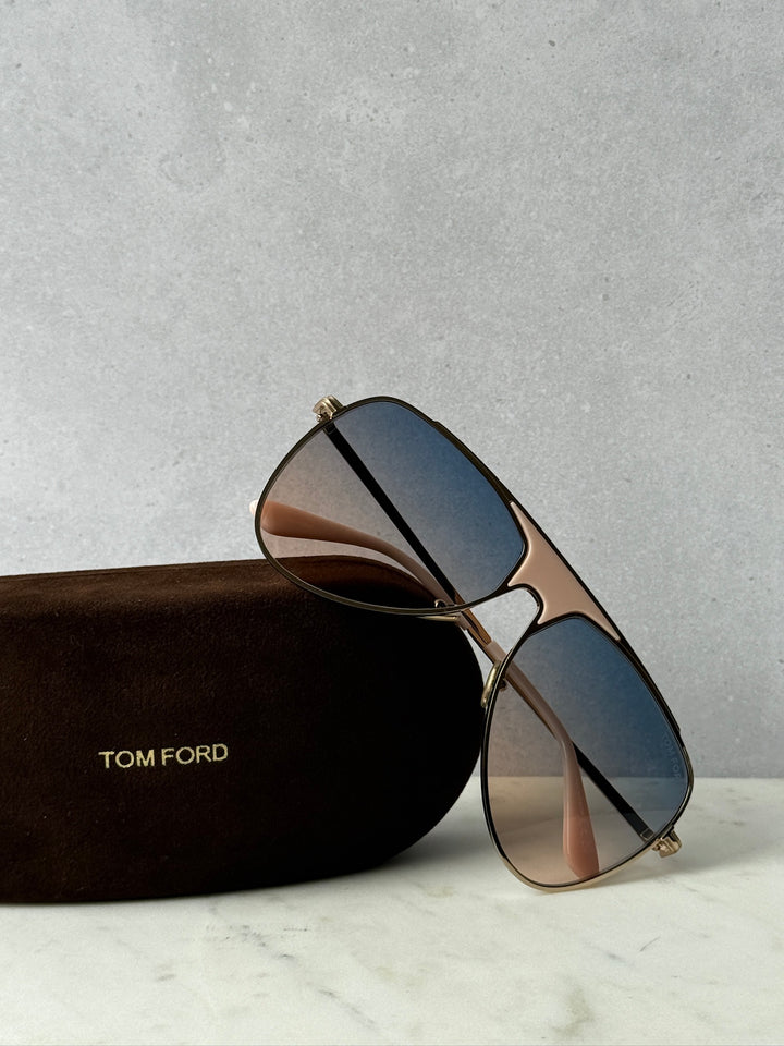 Tom Ford aviator sunglasses with blue gradient lenses and gold metal frame in brown case