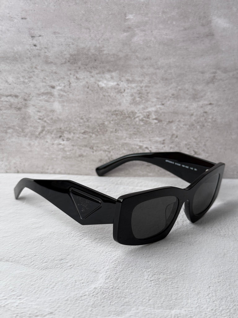 Black PRADA square sunglasses with dark lenses and geometric temple detail