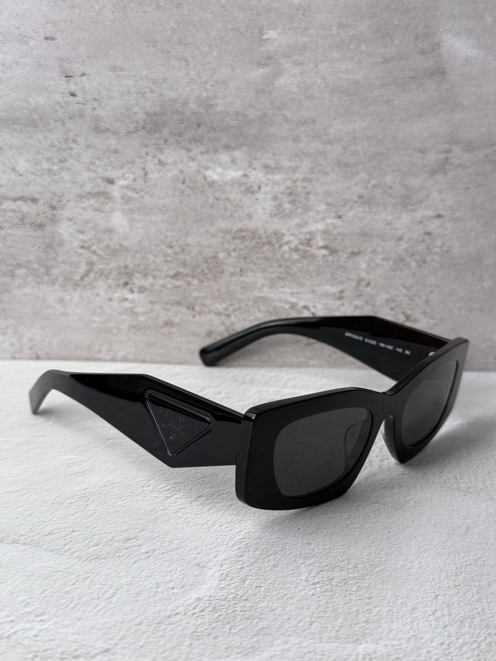 Black PRADA square sunglasses with dark lenses and geometric temple detail