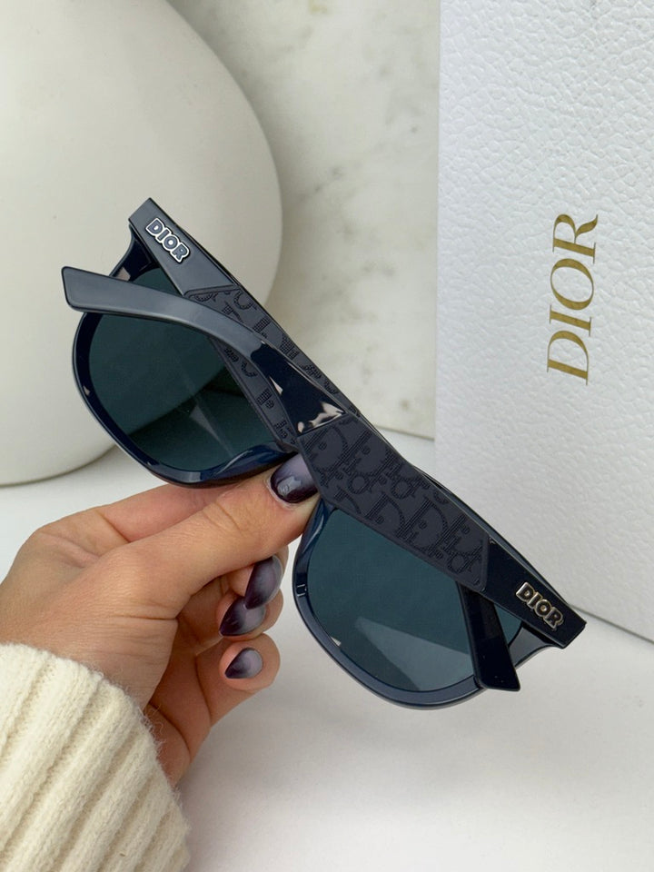 Navy Dior sunglasses with dark mirror lenses and embossed logo arms, side view.