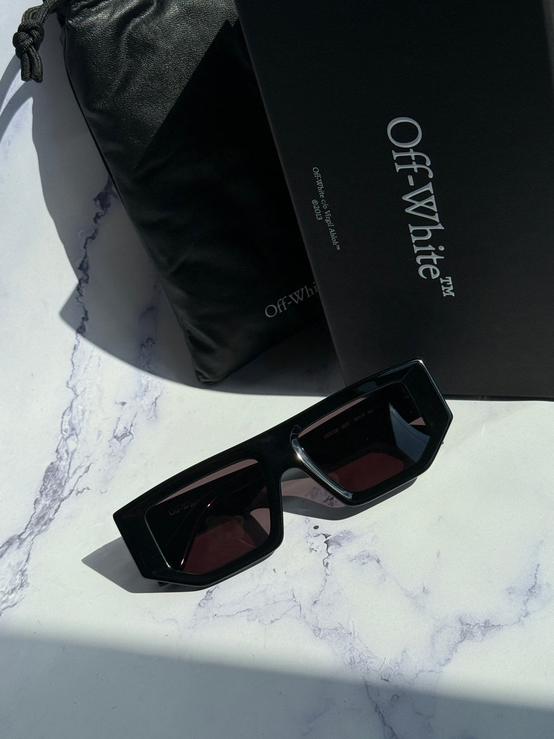 Off-White black square sunglasses with dark lenses, angled view